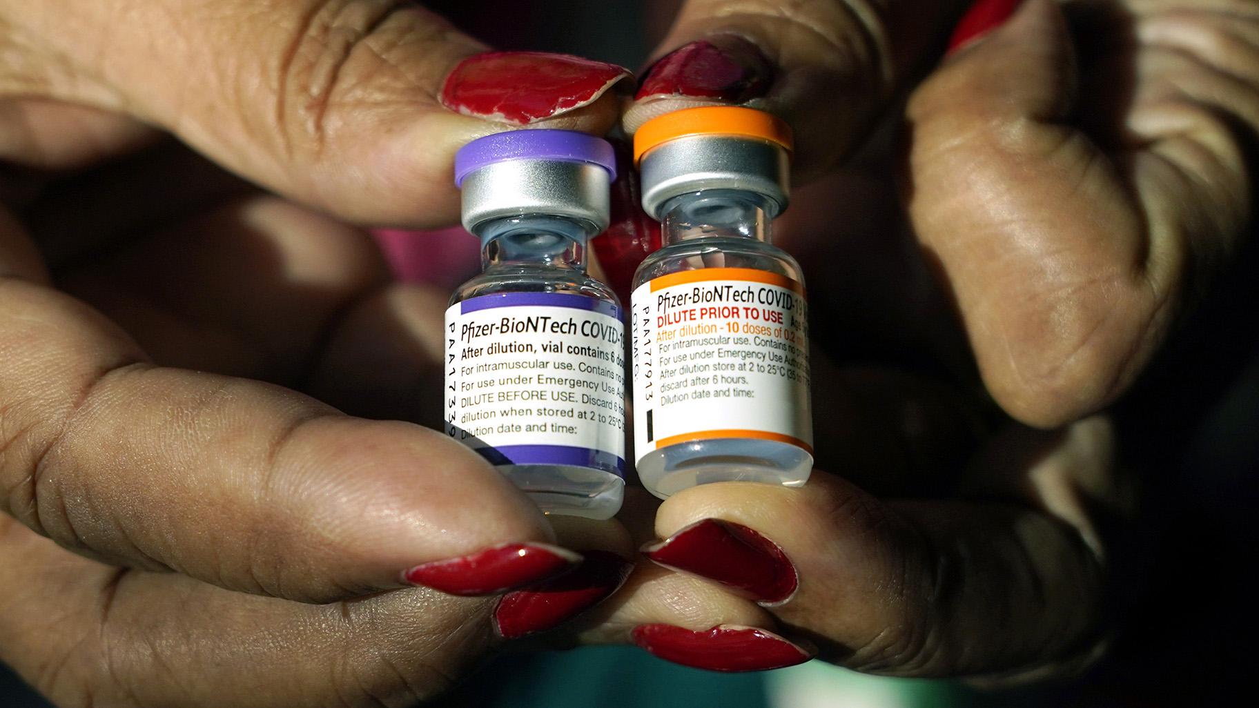A nurse holds a vial of the Pfizer COVID-19 vaccine for children ages 5 to 11, right, and a vial of the vaccine for adults, which has a different colored label, at a vaccination station in Jackson, Miss., Tuesday, Feb. 8, 2022. (AP Photo / Rogelio V. Solis, File)