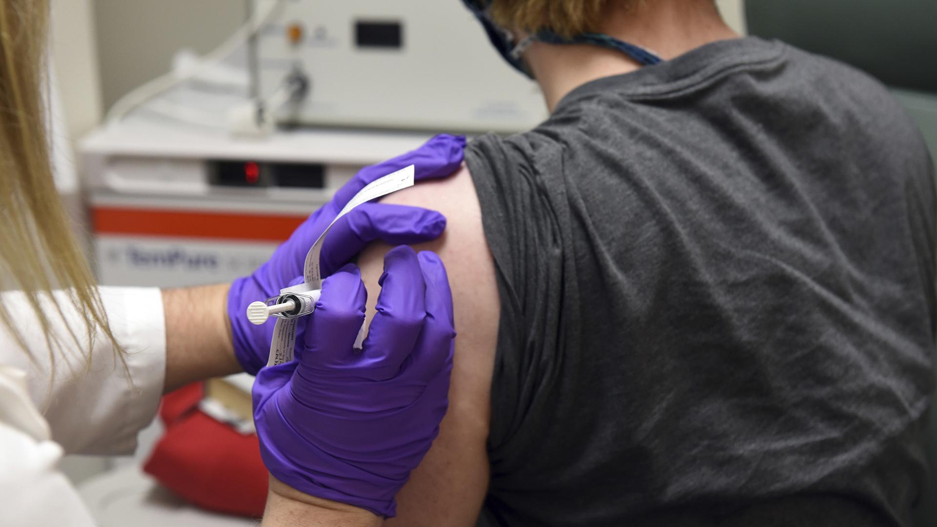 This May 4, 2020 photo from the University of Maryland School of Medicine, the first patient enrolled in Pfizer’s COVID-19 coronavirus vaccine clinical trial at the University of Maryland School of Medicine in Baltimore, receives an injection. (University of Maryland School of Medicine via AP)