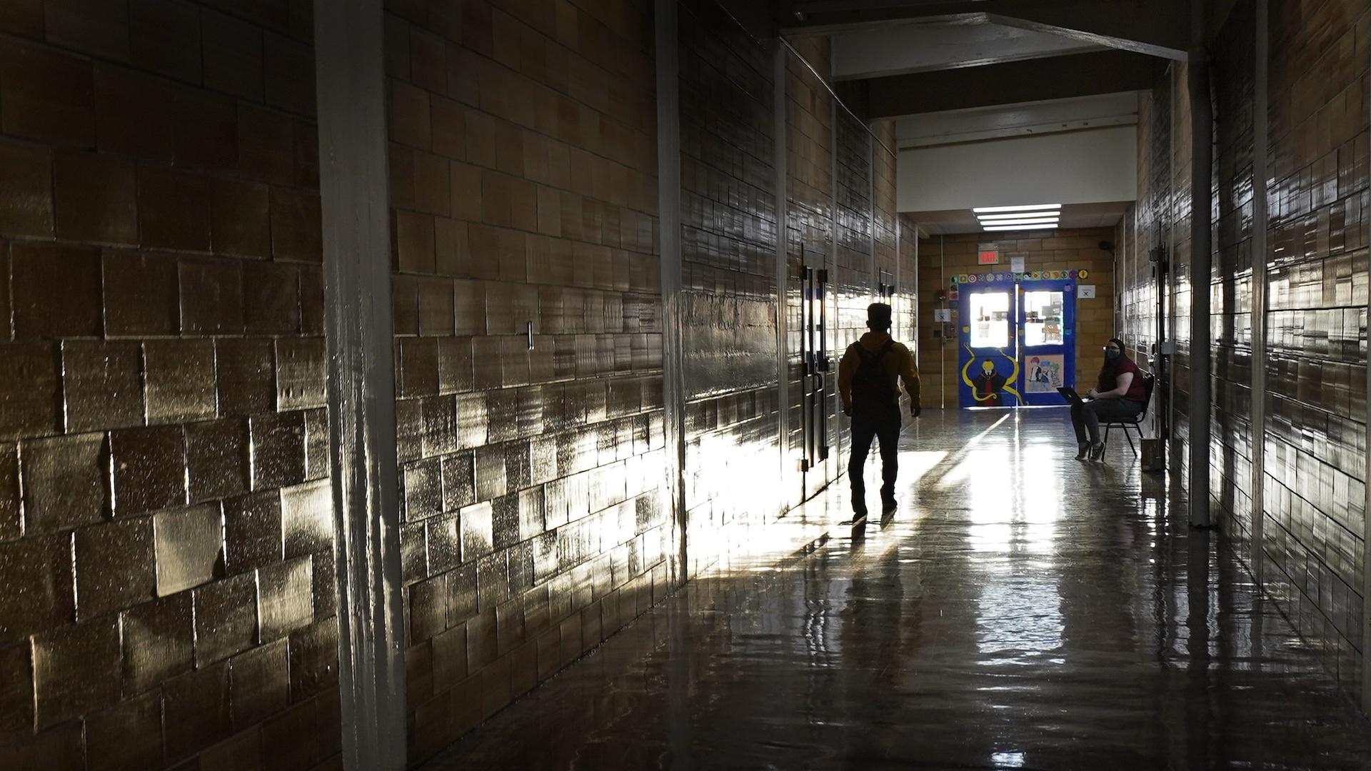 A student walks between classes at Wyandotte High School in Kansas City, Kan., on the first day of in-person learning Wednesday, March 30, 2021. (AP Photo / Charlie Riedel)