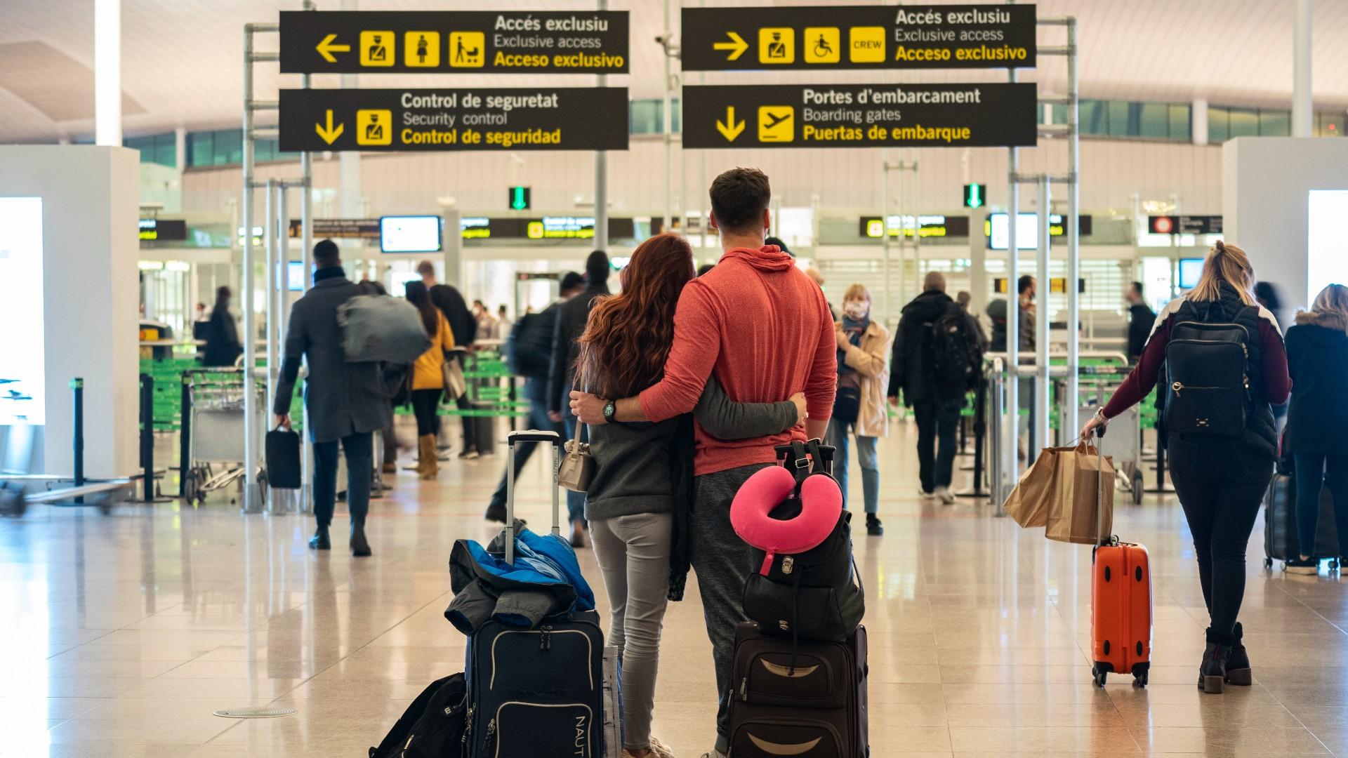 A couple stands outside the security control section inside a terminal of the Barcelona Airport, Wednesday, Dec. 1, 2021. (AP Photo / Joan Mateu Parra)