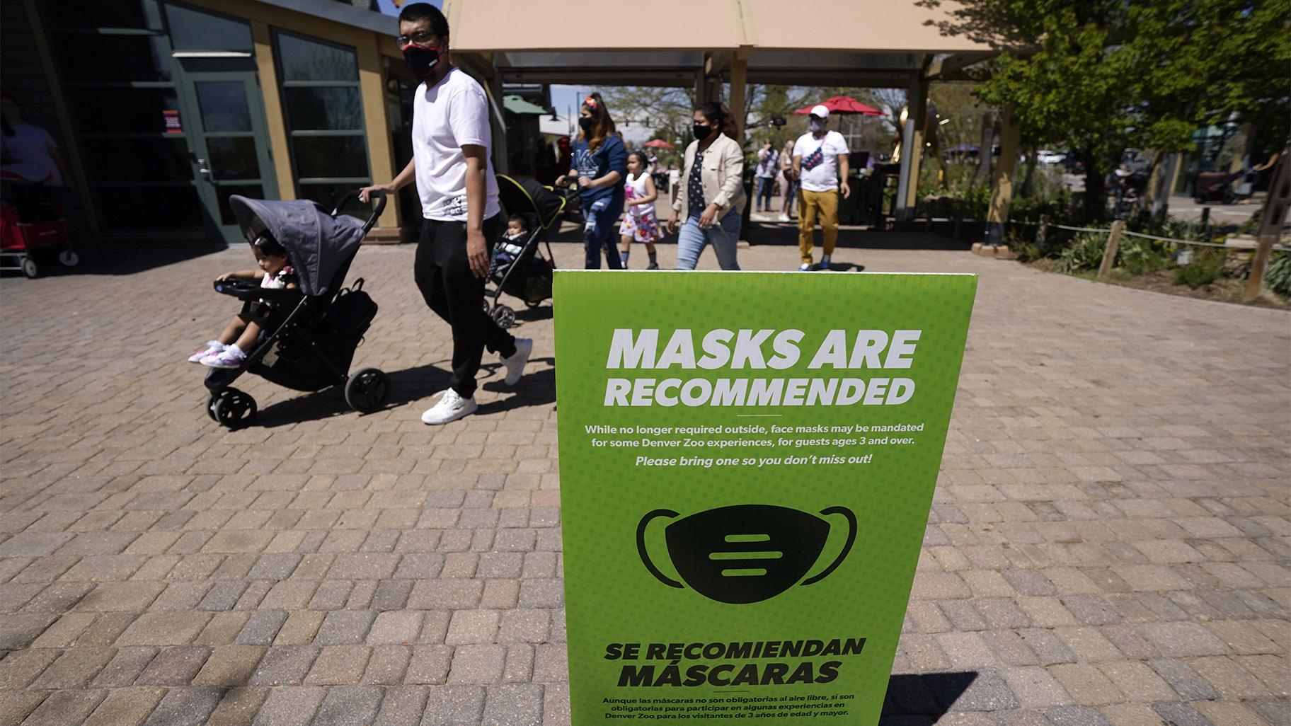 FILE - In this May 13, 2021, file photo, although no longer required outside, a sign advises visitors to wear masks at the Denver Zoo in Denver. (AP Photo / David Zalubowski, File)