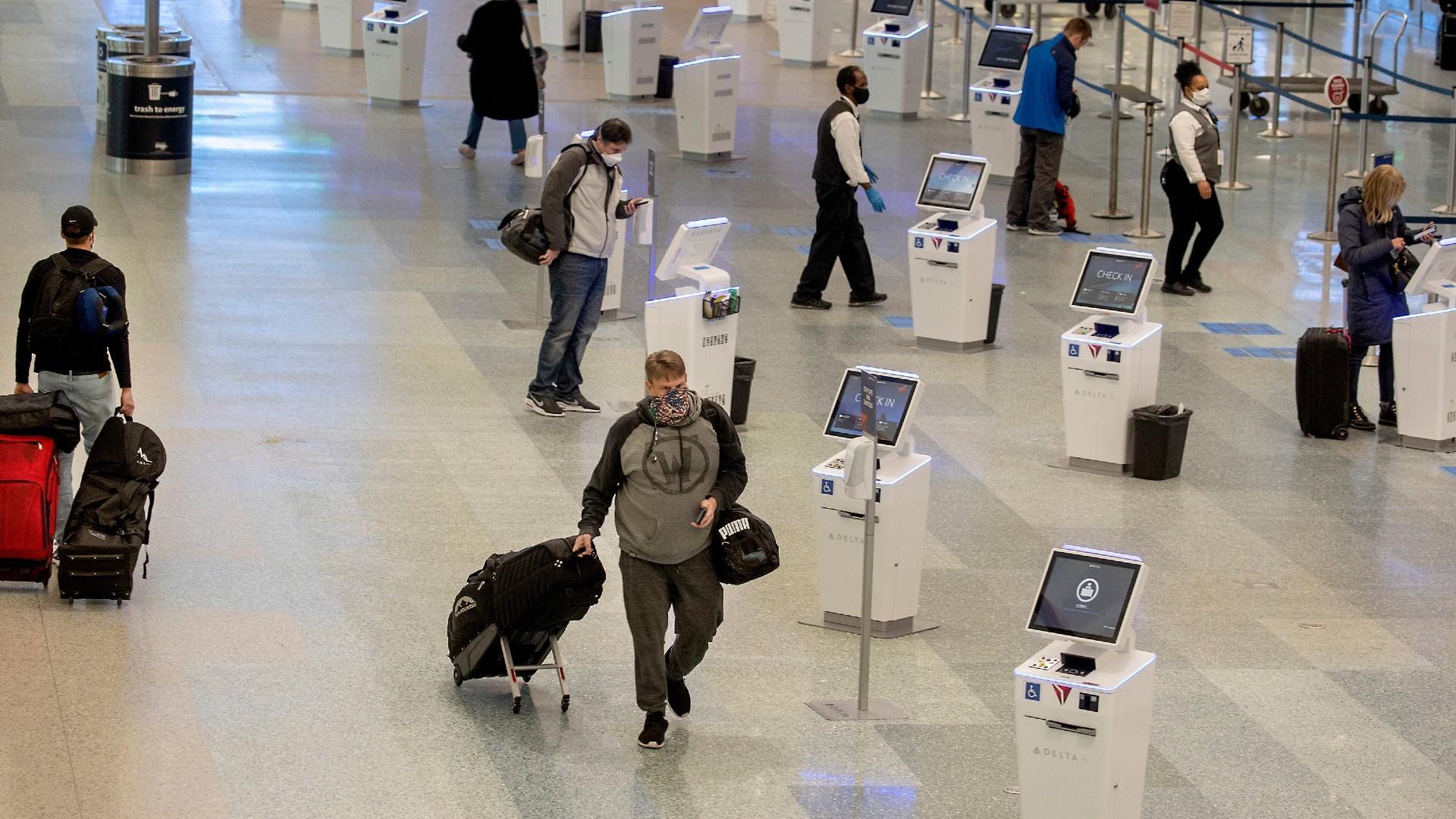 In this Nov. 12, 2020, file photo, travelers make their way through the Minneapolis-St. Paul International Airport during the coronavirus pandemic. (Elizabeth Flores / Star Tribune via AP, File)