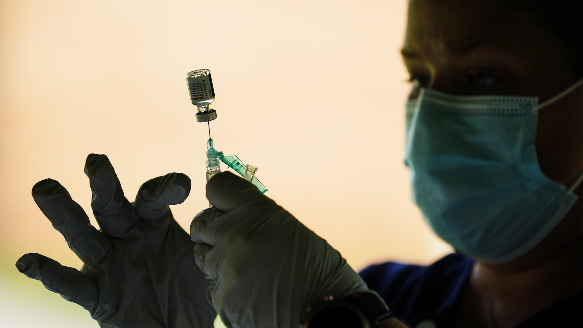 In this Sept. 14, 2021, file photo, a syringe is prepared with the Pfizer COVID-19 vaccine at a clinic at the Reading Area Community College in Reading, Pa. (AP Photo/Matt Rourke, File)
