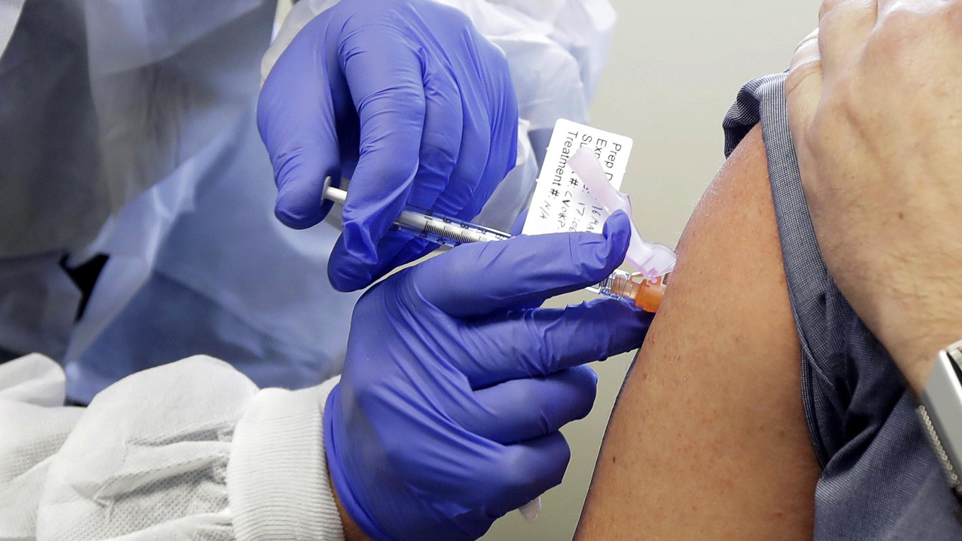 In this March 16, 2020, file photo, Neal Browning receives a shot in the first-stage safety study clinical trial of a potential vaccine for COVID-19, the disease caused by the new coronavirus, at the Kaiser Permanente Washington Health Research Institute in Seattle. The vaccine by Cambridge, Massachusetts-based Moderna Inc., generated antibodies similar to those seen in people who have recovered from COVID-19 in a study of volunteers who were given either a low or medium dose. (AP Photo / Ted S. Warren, Fil