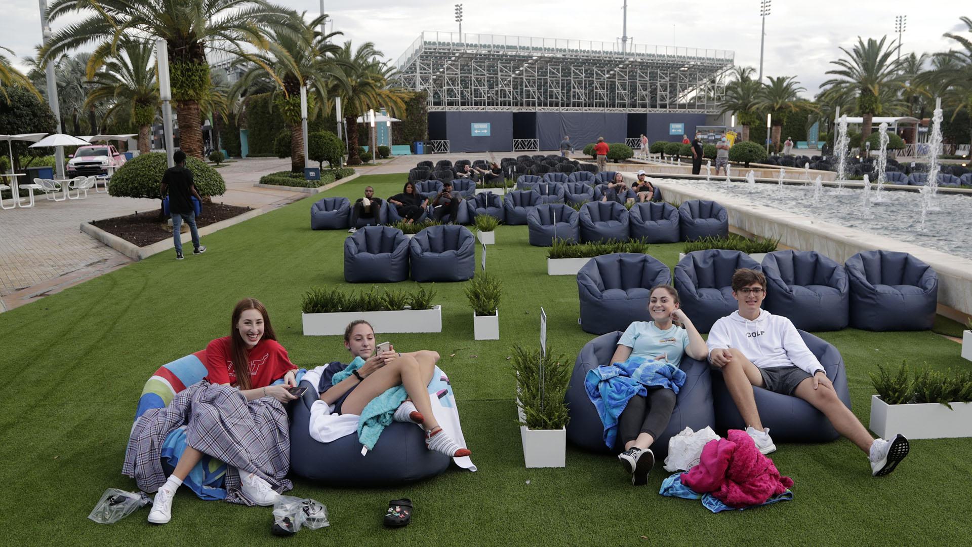 In this Thursday, June 18, 2020 file photo, people sit outdoors to watch a movie as part of a program offered by the Miami Dolphins at Hard Rock Stadium during the coronavirus pandemic in Miami Gardens, Fla. (AP Photo / Lynne Sladky)