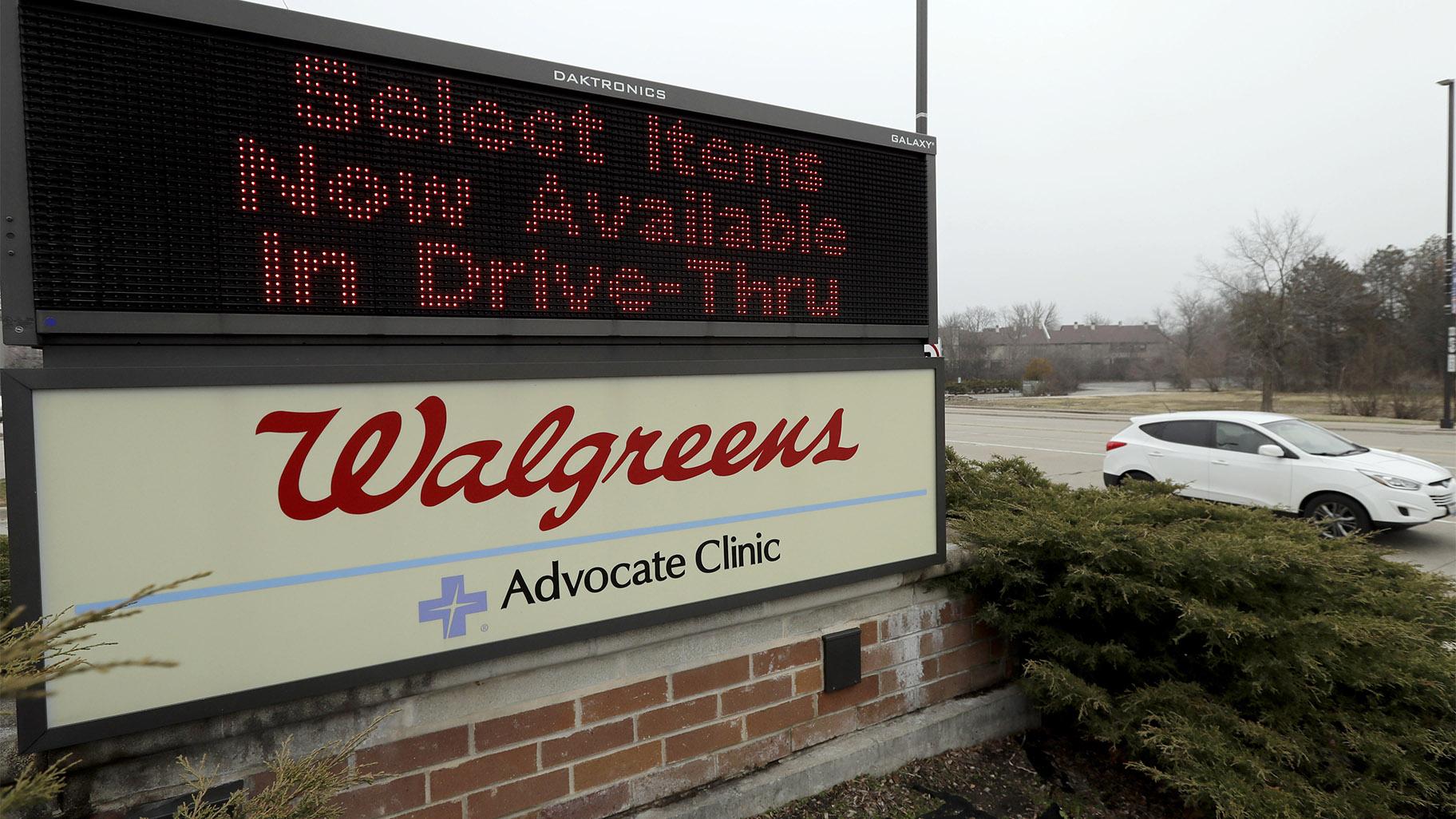 FILE - In this March 27, 2020, file photo, a Walgreens sign is displayed outside the store in Wheeling, Ill. Walgreens will hike starting pay to 5 an hour beginning in October, as employers across the United States continue boosting wages to attract workers. (AP Photo / Nam Y. Huh, File)