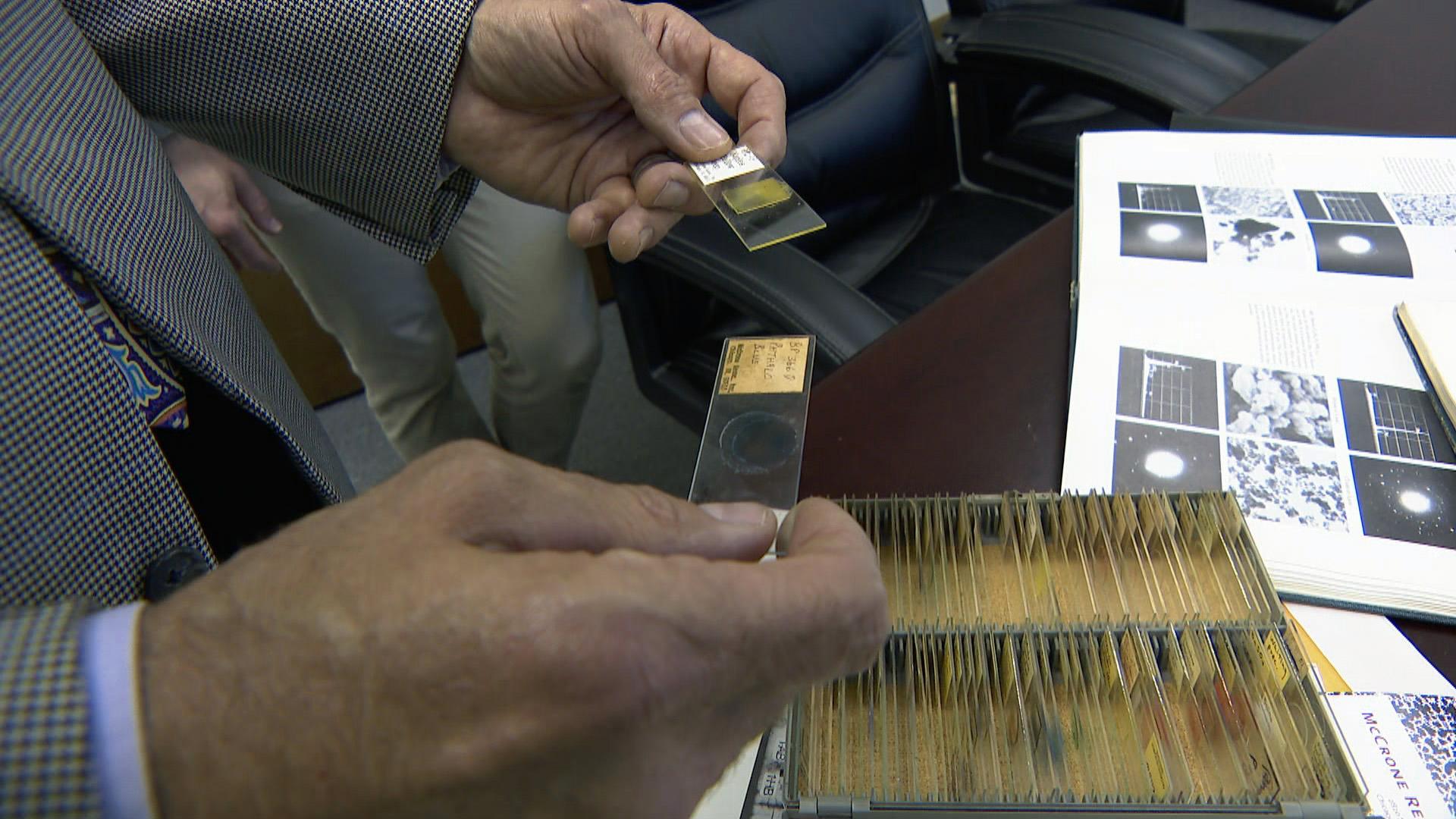 Gary Laughlin handles specimens at the McCrone Research Institute in Bronzeville, founded in 1960 by Walter McCrone. (WTTW News)