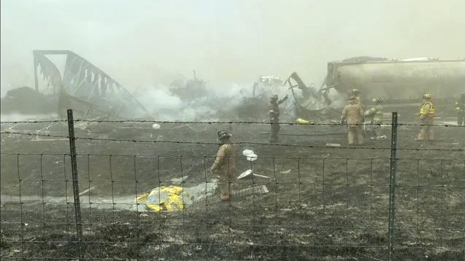First responders work the scene of a crash involving at least 20 vehicles that shut down a highway in Illinois, Monday, May 1, 2023. Illinois State Police say a windstorm that kicked up clouds of dust in south-central Illinois has led to numerous crashes and multiple fatalities on Interstate 55. (WICS TV via AP)