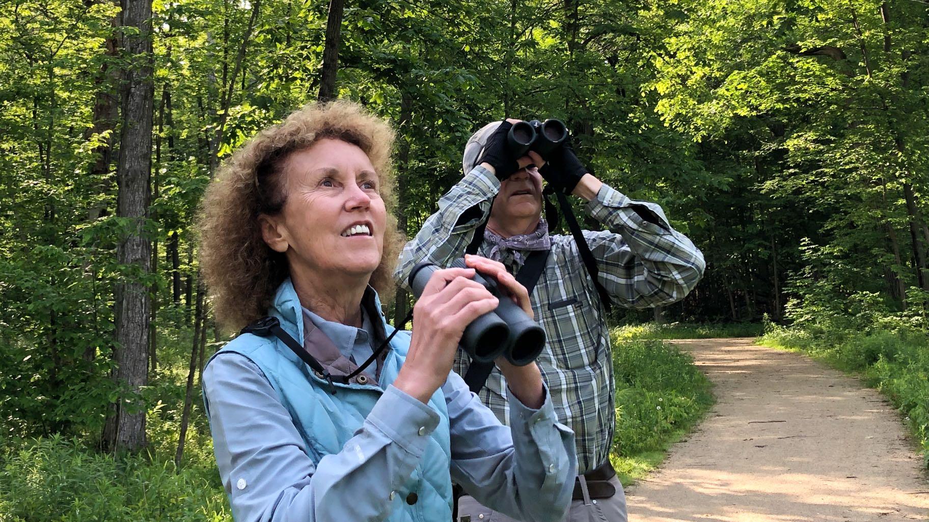 Charlotte Pavelka and Doug Reitz on bird monitoring duty, June 2022, at Captain Daniel Wright Woods. (Patty Wetli / WTTW News)