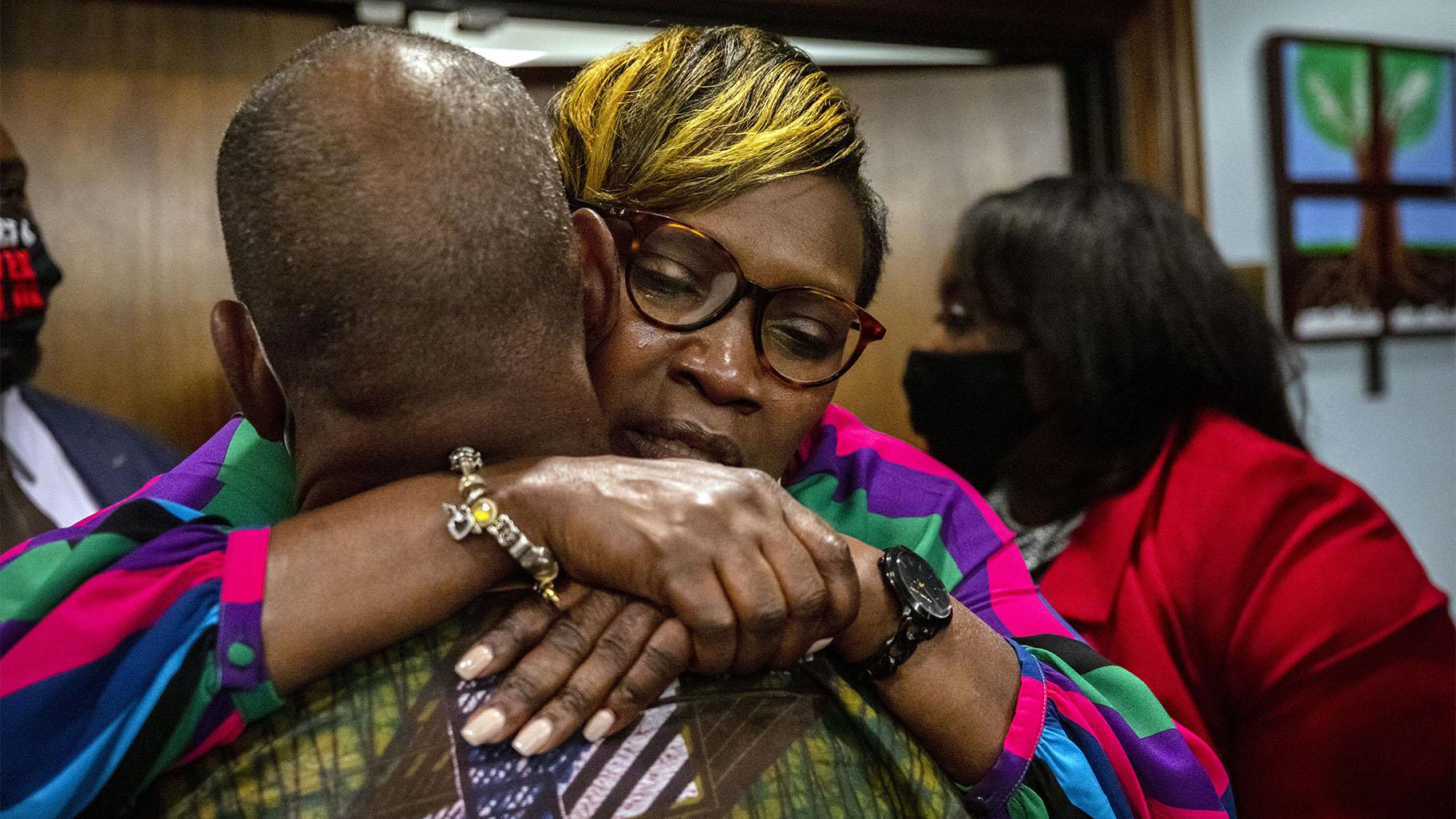 Ahmaud Arbery's mother, Wanda Cooper-Jones his hugged by a supporter after the jury convicted Travis McMichael in the trial of McMichael, his father, Greg McMichael, and neighbor, William "Roddie" Bryan, Wednesday, Nov. 24, 2021. (AP Photo / Stephen B. Morton, Pool, File)  