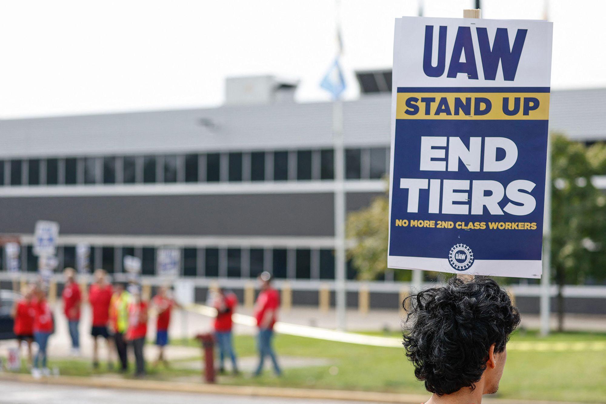 AW members and workers hold signs outside the Ford's Chicago Assembly Plant after walking off their jobs in Chicago, Illinois, on Sept. 29, 2023. (Kamil Krzaczynski / AFP / Getty Images)
