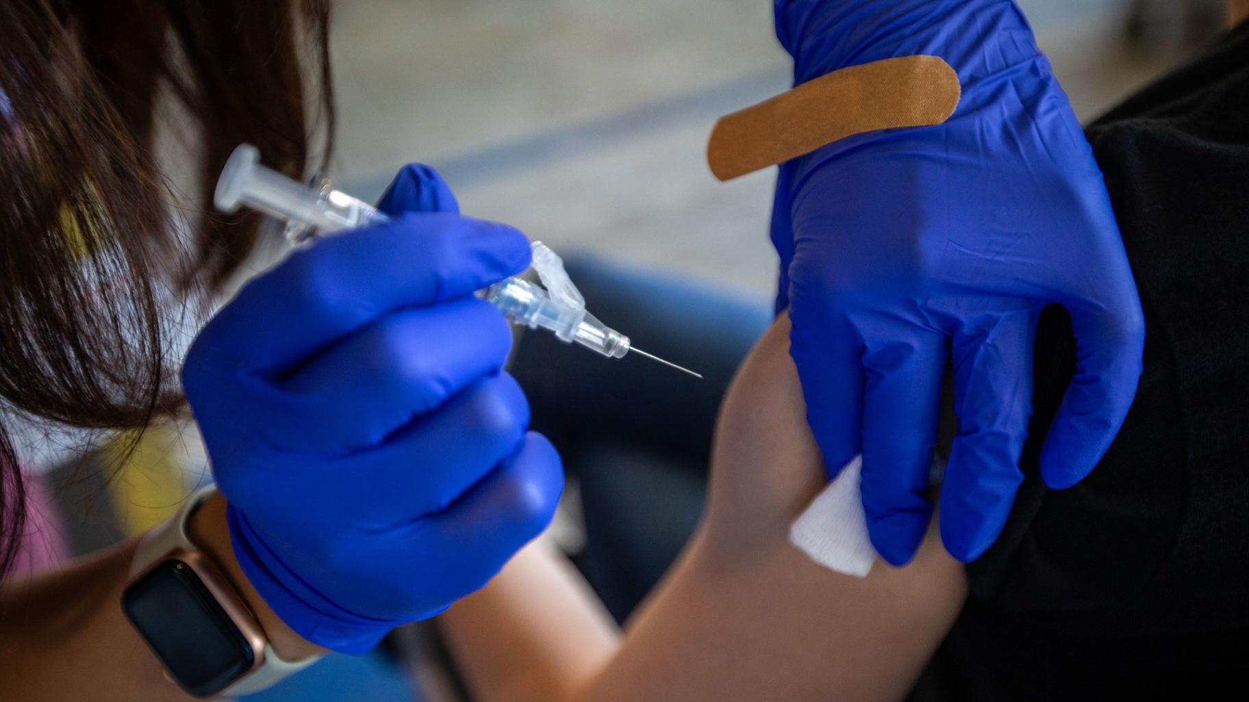 Fewer than two in five adults have gotten their flu vaccine this season, and only about one in six have gotten the latest COVID-19 vaccine, according to CDC data. (Francine Orr / Los Angeles Times / Getty Images)
