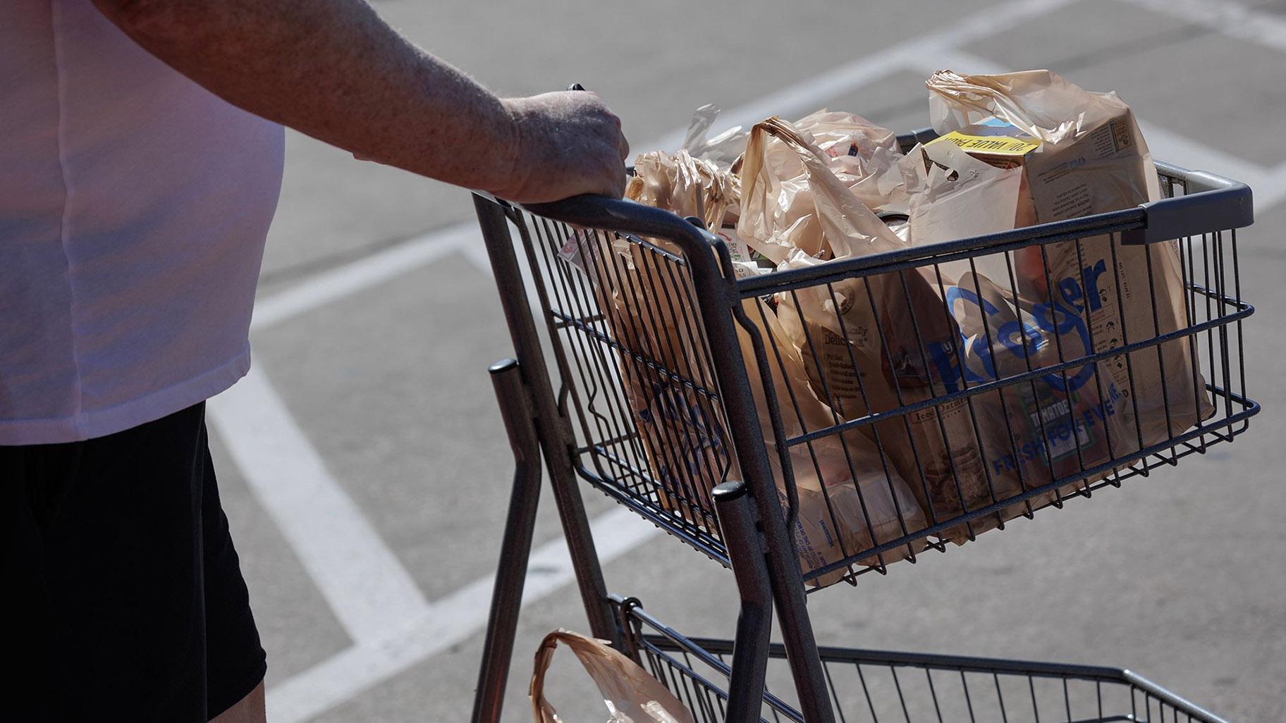 A shopper pushes a shopping cart outside a Kroger grocery store in Dallas, Texas, on Feb. 21, 2024. (Shelby Tauber / Bloomberg / Getty Images via CNN Newsource)