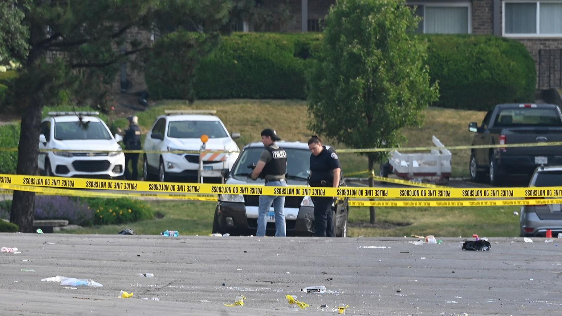 Investigators look over the scene of an overnight mass shooting in Willowbrook, Illinois, Sunday. (Matt Marton / AP)