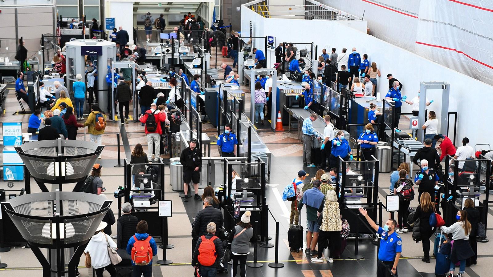 Airline passengers here wait at a Transportation Security Administration (TSA) checkpoint to clear security before boarding flights in Denver, Colorado on April 19. (Patrick T. Fallon / AFP / Getty Images via CNN)