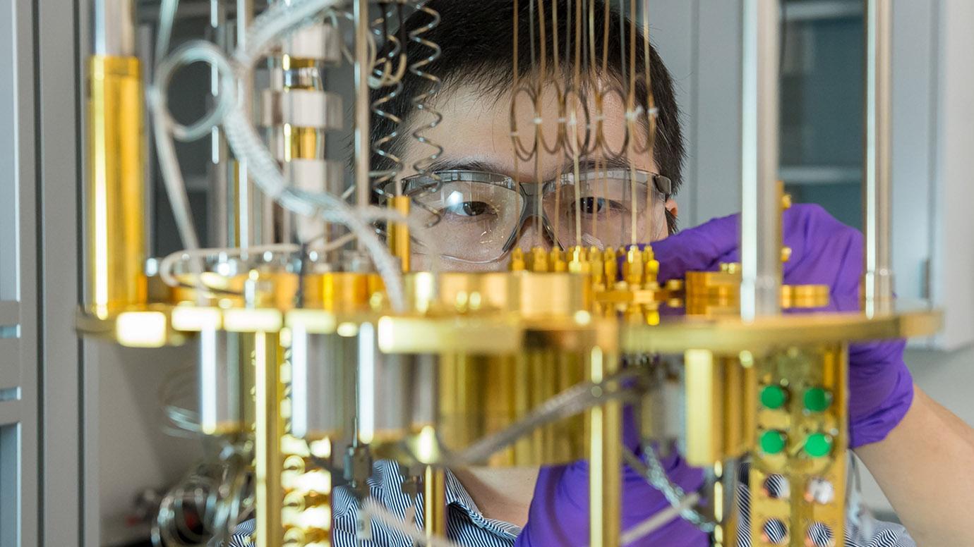 Two new research centers headquartered at Argonne National Laboratory and Fermi National Accelerator Laboratory will boost transformational breakthroughs in quantum information science. Here, Argonne scientist Dafei Jin observes a dilution refrigerator—a cryogenic cooling device for materials used for quantum computing. (Photo by Mark Lopez / Argonne National Laboratory)