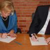 Pucinski and Flannigan sign their release forms.