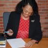 Joy Virginia Cunningham signs her release form.
