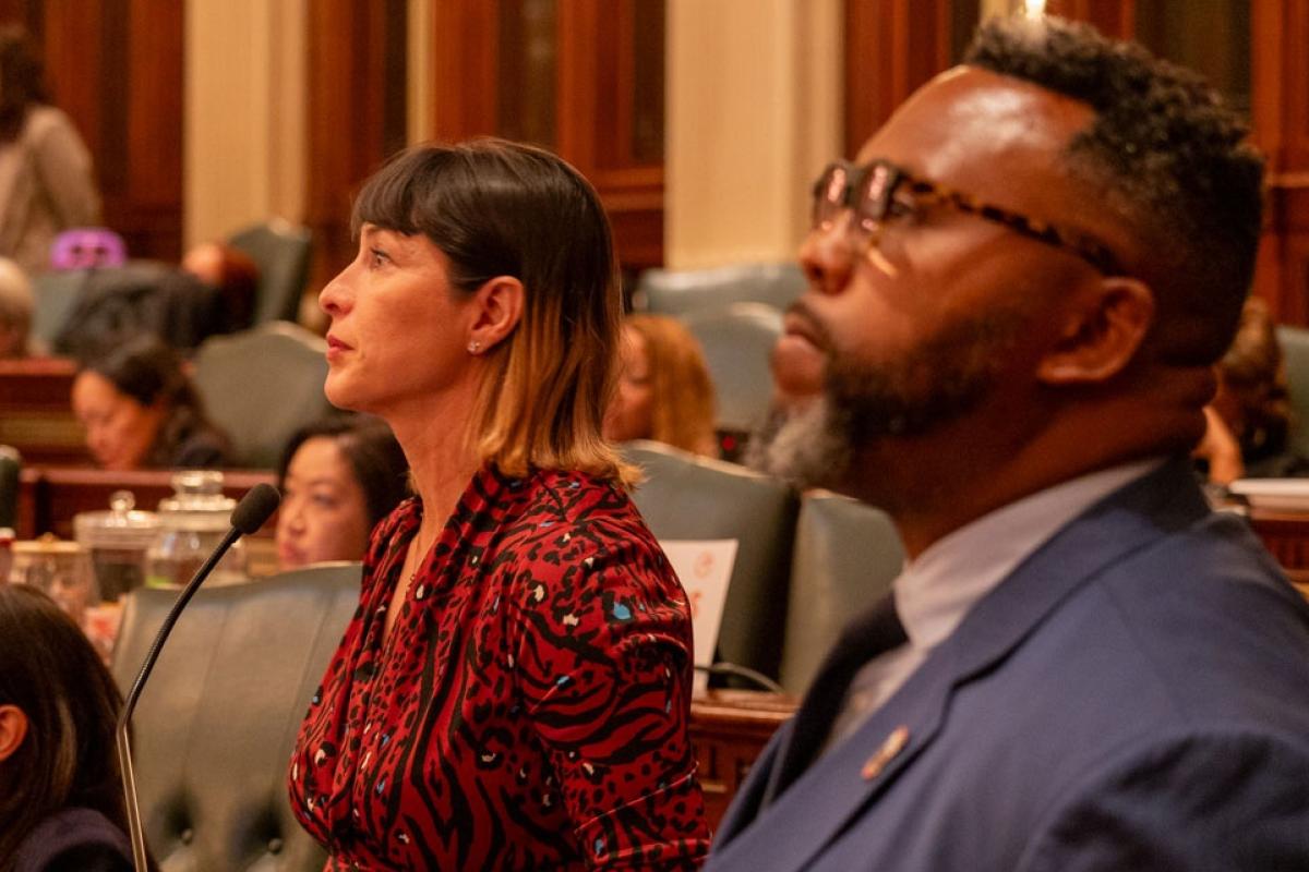  Reps. Eva-Dina Delgado and Kam Buckner watch the House of Representatives discuss their proposal to reform Chicagoland public transit. The two Chicago Democrats led a House working group tasked with overseeing negotiations. (Capitol News Illinois photo by Andrew Adams) 