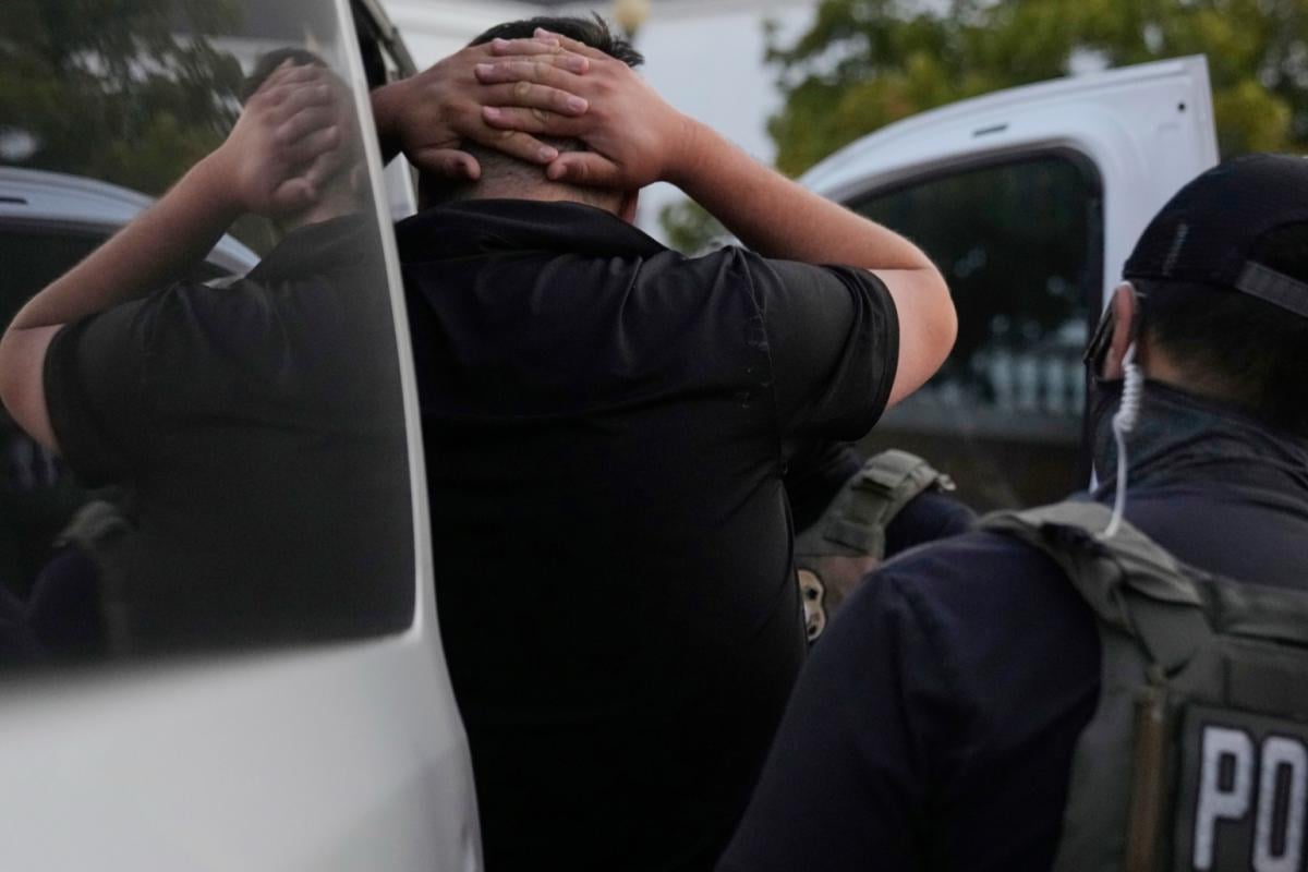 U.S. Immigration and Customs Enforcement agents make an arrest during an early morning operation in Park Ridge, Ill., Friday, Sept. 19, 2025. (AP Photo / Erin Hooley)