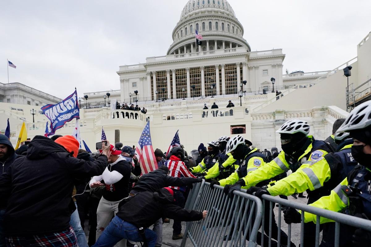 Insurrectionists loyal to President Donald Trump try to break through a police barrier, Wednesday, Jan. 6, 2021, at the Capitol in Washington. (AP Photo / Julio Cortez, File)