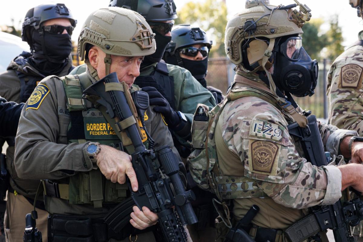 Border Patrol chief Gregory Bovino stands with federal immigration enforcement agents during a skirmish with protesters in Little Village neighborhood, Chicago Thursday, Oct. 23, 2025. (Anthony Vazquez / Chicago Sun-Times via AP)