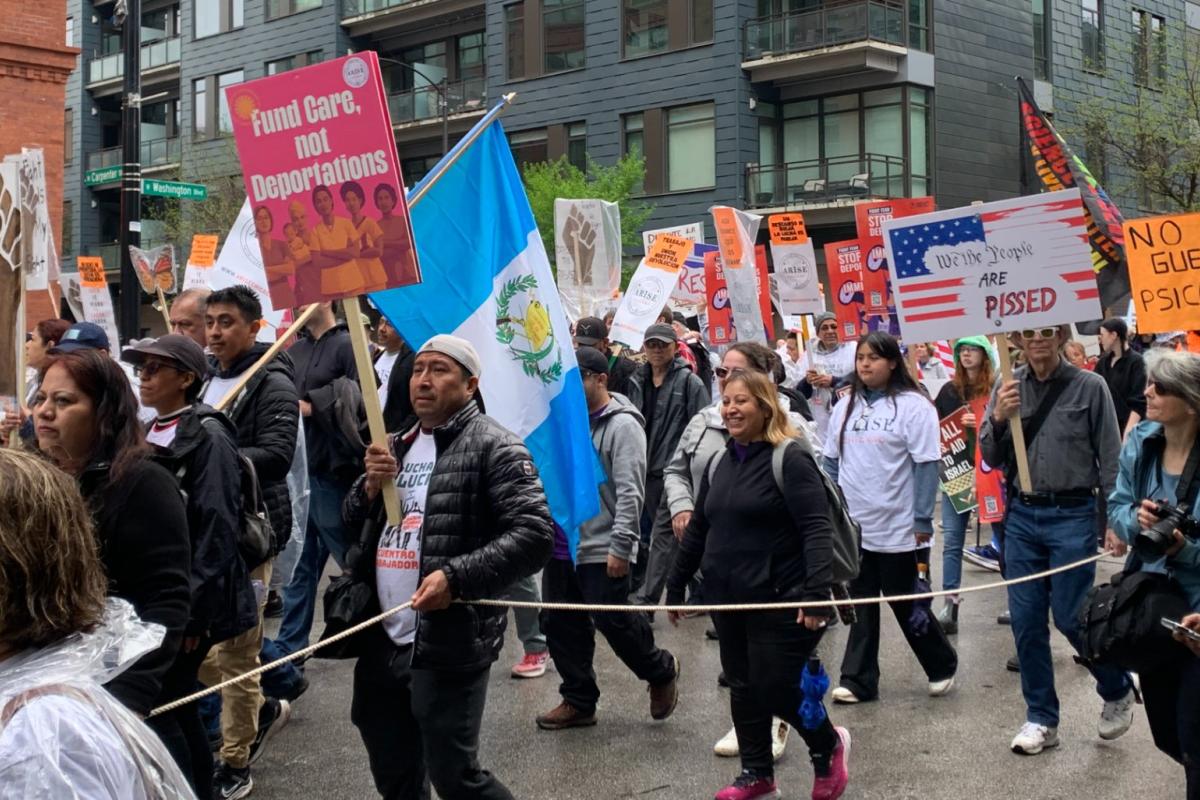 Protesters march on Washington Boulevard near Union Park to protest the Trump administration’s policies on May Day, or International Workers’ Day, on May 1, 2025. (Eunice Alpasan / WTTW News)