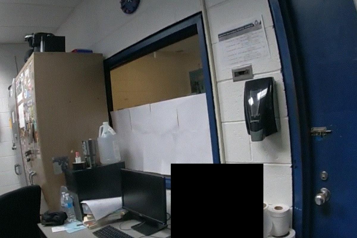The partly obscured window of the holding cell at the Grand Crossing (3rd District) Police District where Irene Chavez died in December 2021. (Civilian Office of Police Accountability)