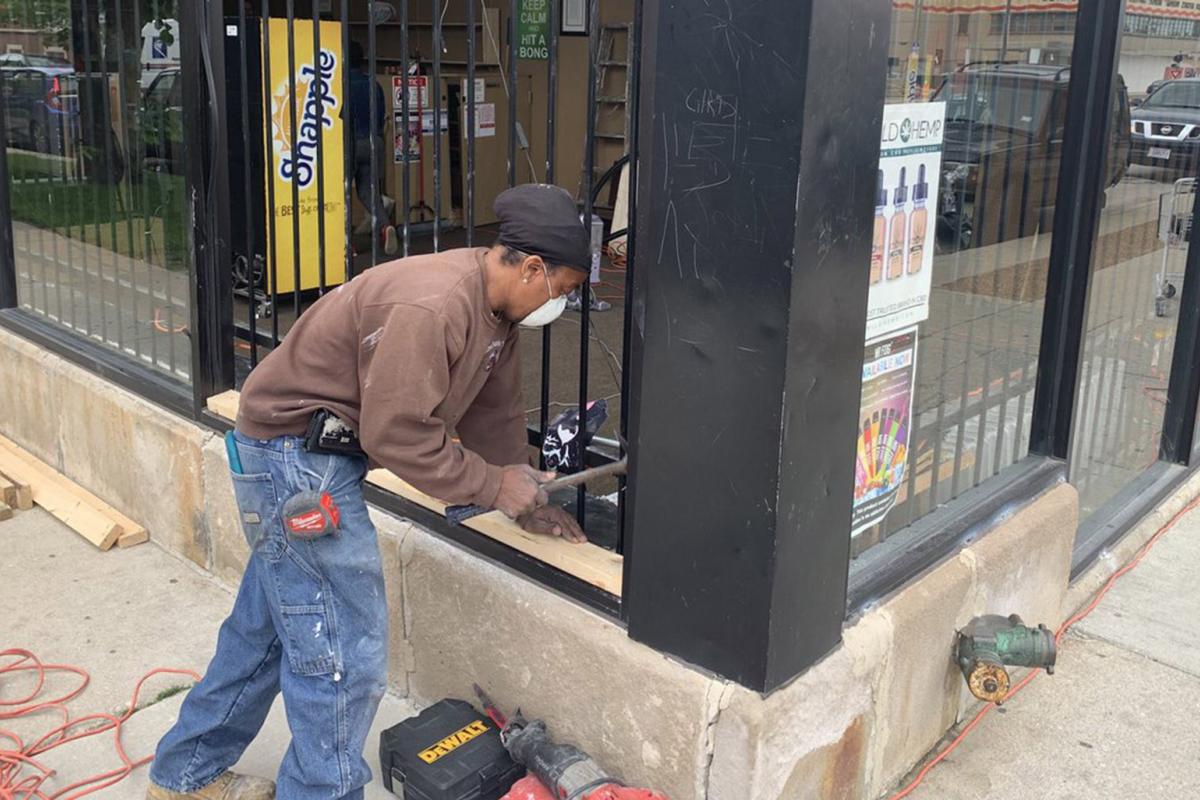 Crews start boarding up the 3 Smokin Sisters Tobacco Shop on 71st Street in Chicago’s South Shore neighborhood. Shop owners emptied the store of inventory following looting on Sunday, May 31, 2020. (@paschutz / Twitter)