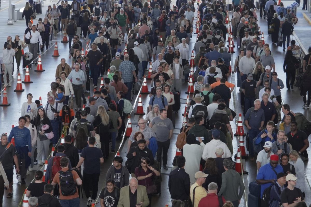 Travelers line up at a TSA checkpoint at George Bush Intercontinental Airport in Houston, Thursday, March 26, 2026. (AP Photo / Lekan Oyekanmi)