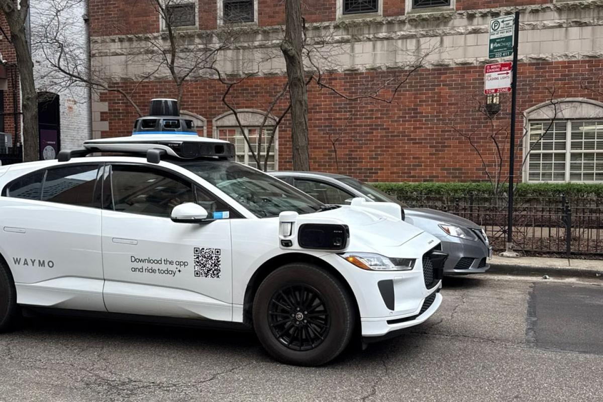 A Waymo vehicle drives through Chicago’s Near North Side on March 20, 2026, as the company begins testing and mapping the city. (Georgia Epiphaniou / Medill Illinois News Bureau) 