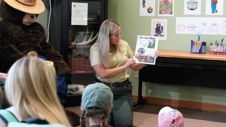 Emily Harvey, former natural resource education specialist at Midewin National Tallgrass Prairie, teaching youngsters about wildfire prevention. (U.S. Forest Service) 