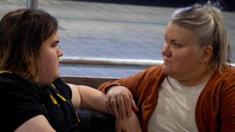 Julia Kathary (right) listens to her daughter, Connie Kathary (left), talk about her day at school at a marketplace in Indianapolis, Indiana, earlier this year. (Carly Gist for the Saluki Local Reporting Lab / Capitol News Illinois)