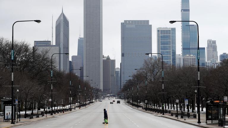 An elderly woman walks across the usually busy Columbus Drive that splits Chicago’s Grant Park in half, on the first work day since Illinois Gov. J.B. Pritzker gave a shelter in place order last week, Monday, March 23, 2020, photo, in Chicago. (AP Photo / Charles Rex Arbogast) An elderly woman walks across the usually busy Columbus Drive that splits Chicago’s Grant Park in half, on the first work day since Illinois Gov. J.B. Pritzker gave a shelter in place order last week, Monday, March 23, 2020, photo, in Chicago. (AP Photo / Charles Rex Arbogast)