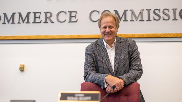 Doug Scott stands for a photograph in the hearing room at the Illinois Commerce Commission offices in downtown Chicago. (Andrew Adams / Capitol News Illinois)