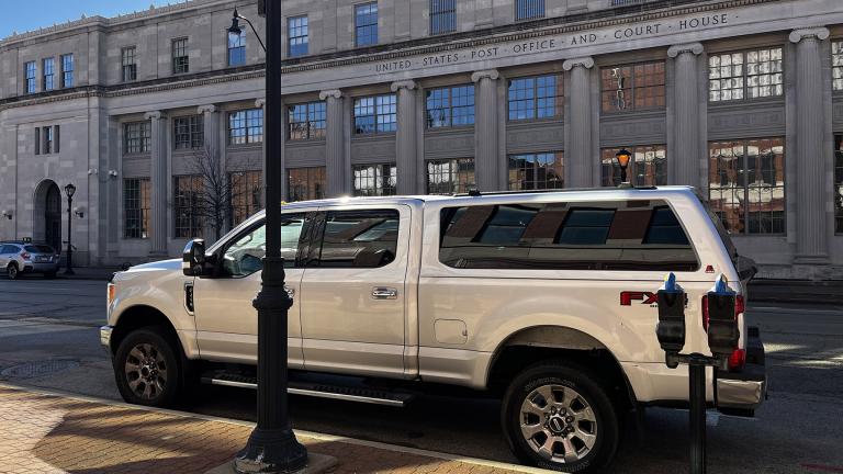 Former GOP state Sen. Sam McCann’s pickup truck – the same make and model of a truck named as an illicit purchase in his indictment – is parked outside of the Paul Findley Federal Courthouse in Springfield, where McCann was supposed to have faced a corruption trial this week. (Hannah Meisel / Capitol News Illinois)