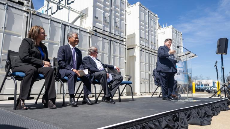 Gov. J.B. Pritzker speaks at G&W Electric Co. in Bolingbrook on April 15, 2024, to highlight its microgrid, which includes one of the largest batteries in the country. Also pictured (left to right): Bolingbrook Mayor Mary Alexander-Basta, Commonwealth Edison CEO Gil Quiniones and G&W chair and owner John Mueller. (Andrew Adams / Capitol News Illinois)