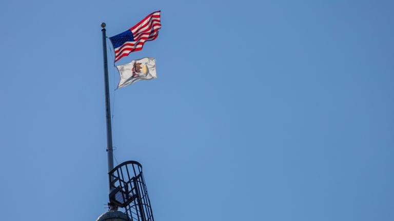 Flags fly atop the Illinois Capitol dome. (Andrew Adams / Capitol News Illinois)