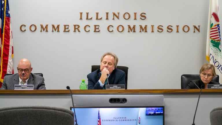 Illinois Commerce Commission Chair Dough Scott is pictured alongside commissioners Michael Carrigan (left) and Ann McCabe (right) at a November 2023 meeting in Springfield. (Jerry Nowicki / Capitol News Illinois)