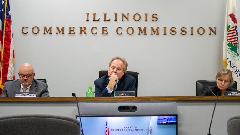 Illinois Commerce Commission Chair Doug Scott is pictured alongside commissioners Michael Carrigan, left, and Ann McCabe, right, at a November 2023 meeting in Springfield. (Jerry Nowicki / Capitol News Illinois)