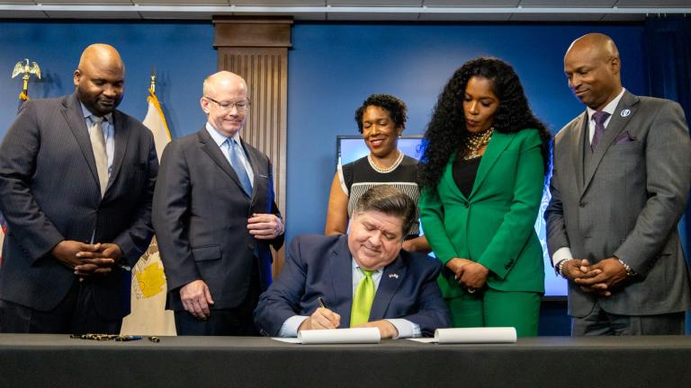 Flanked by the lieutenant governor and legislative leaders, Gov. J.B. Pritzker on June 5, 2024, signs the $53.1 billion fiscal year 2025 state budget into law after months of negotiations. (Andrew Adams / Capitol News Illinois)