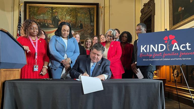 Gov. J.B. Pritzker signs the KIND Act on Wednesday, Feb. 5, 2025, at the Illinois Capitol. The new law requires the state to prioritize family members when placing children in foster care. (Bridgette Fox / Capitol News Illinois)