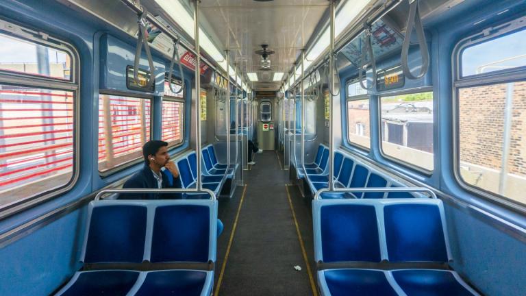 A couple of passengers ride a southbound Red Line “L” train in Chicago. (Andrew Adams / Capitol News Illinois)
