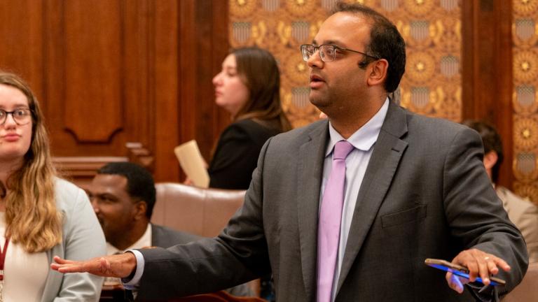 Sen. Ram Villivalam, D-Chicago, signals to a parliamentary officer during the vote on his transit reform package just before midnight on May 31. (Capitol News Illinois photo by Andrew Adams) 