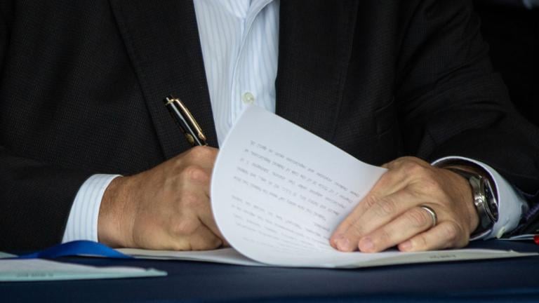 Gov. JB Pritzker signs a bill into law on Aug. 14, 2025, in Springfield. (Jerry Nowicki / Capitol News Illinois) 