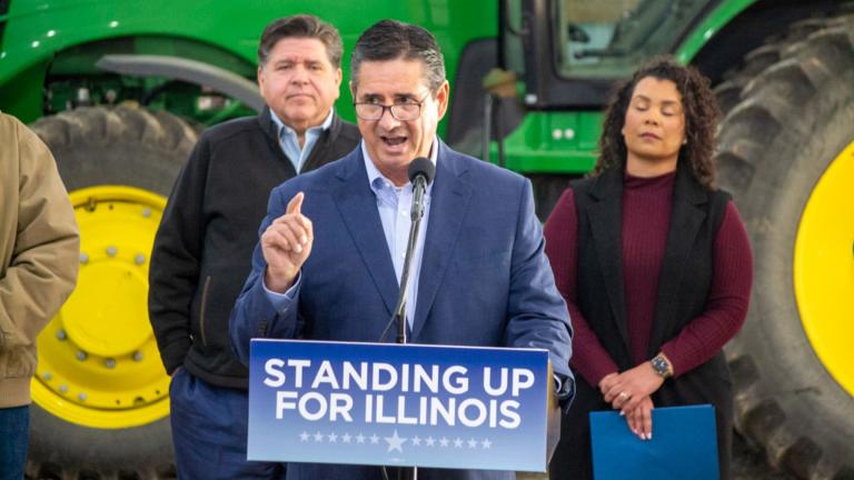 Jerry Costello II, director of the Illinois Department of Agriculture, speaks at a Christian County farm alongside Gov. JB Pritzker (left) and Cameron Joost, assistant director of the Illinois Department of Commerce and Economic Opportunity. The group discussed the impact of tariffs on Illinois farmers in an October visit. (Jerry Nowicki / Capitol News Illinois)