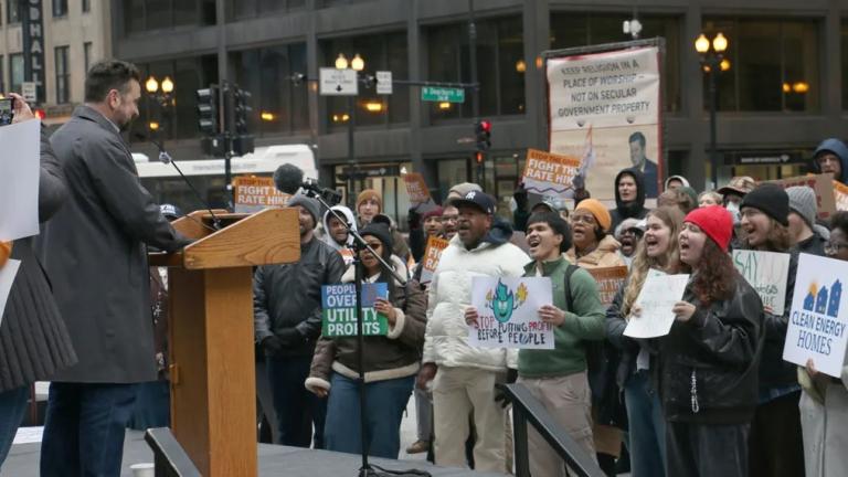 Customers and utility watchdogs took to Daley Plaza with signs to denounce Peoples Gas’ rate hike request on April 1, 2026. (Maggie Dougherty / Capitol News Illinois) 
