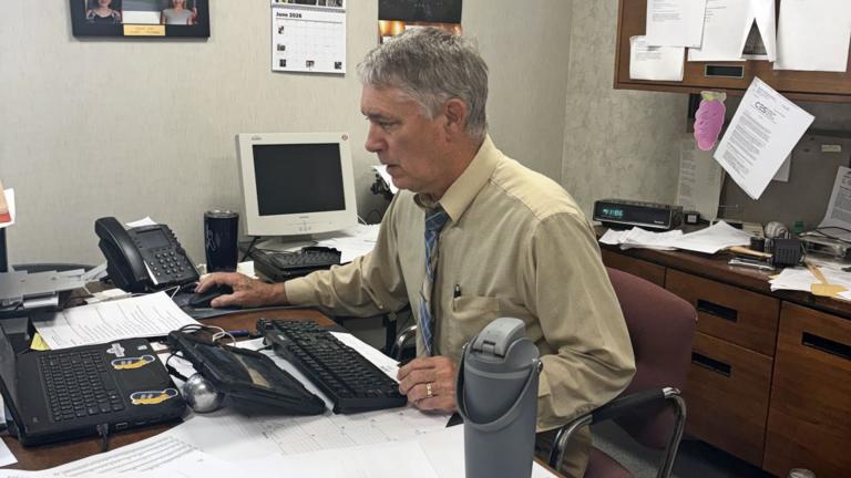 Gary Scott sits at his desk in the WLDS-WEAI office. (Photo provided by Gary Scott)