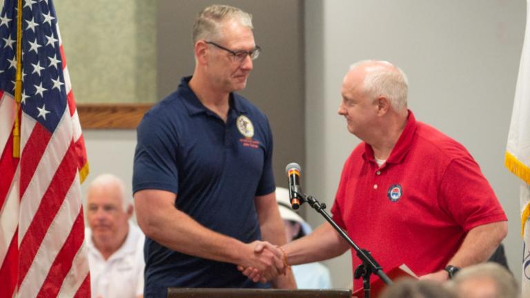 Illinois Senate Republican Leader John Curran shakes hands with new state Party Chair Bob Grogan at a meeting of the Republican State Central Committee in Springfield on Aug. 20, 2026. (Jerry Nowicki / Capitol News Illinois)