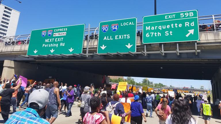 Protesters move into the home stretch Saturday under a 71st Street overpass filled with hundreds more onlookers. (Matt Masterson / Chicago Tonight)